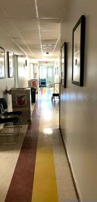 Office corridor with a dehumidifier drying the carpet