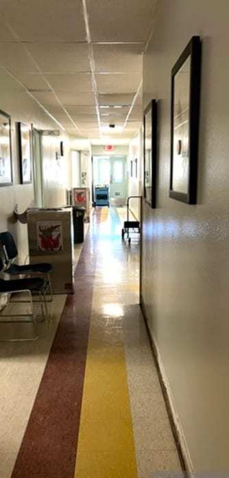 Office corridor with a dehumidifier drying the carpet