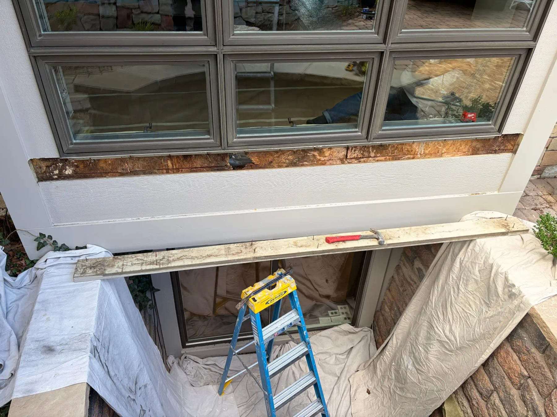 Window sill removed with the framing below exposed and the room protected