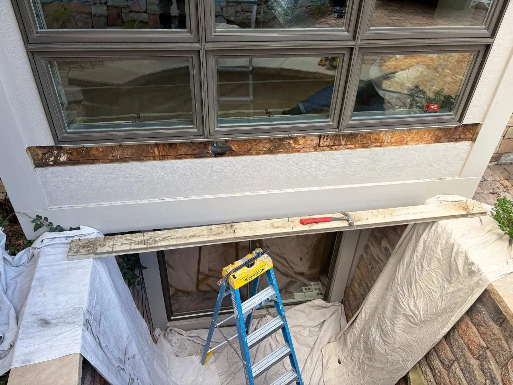 Window sill removed with the framing below exposed and the room protected